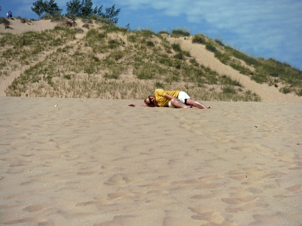 Karen Duquette plops down into the sand